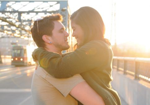 64) Kiss on a bridge in the sunset